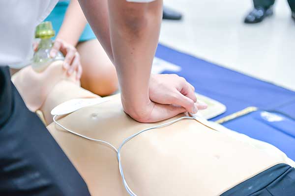 Demonstrating Chest Compressions on CPR Doll during Basic Life Support Level 2